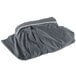 A grey table skirt in a grey bag with a white stripe.