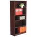 A mahogany Alera bookcase with books and orange folders.