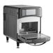 A black and silver TurboChef Sota rapid cook oven with a door open and a screen on a counter.