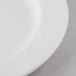 A close-up of a Libbey white porcelain plate with a white rim.