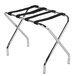 A chrome metal luggage rack with black straps.