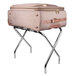 A CSL chrome metal luggage rack holding a suitcase.