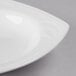 A close-up of a white Libbey Elan Square Royal Rideau Soup Bowl with a white rim.