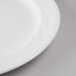 A close-up of a Libbey white porcelain plate with a white rim.