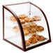 A Cal-Mil iron bakery display case with bagels on it.