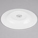 A white Libbey Royal Rideau porcelain tea saucer with black text.