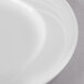 A close-up of a Libbey Royal Rideau white porcelain plate with a wide rim.