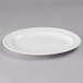 A white Libbey porcelain platter with a rim on a gray surface.