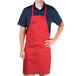 a man wearing a red apron