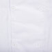 A close up of a white Chef Revival short sleeve coat with buttons.