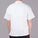 A man wearing a white Chef Revival short sleeve chef jacket with mesh back.