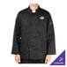 A man wearing a black Chef Revival chef jacket with a green logo on the chest.