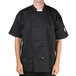 A man wearing a black Chef Revival chef coat.