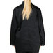 A woman wearing a black Chef Revival chef jacket.