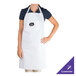 A woman wearing a white Chef Revival apron with a purple logo.