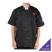 A man wearing a black Chef Revival short sleeve chef jacket with a mesh back.