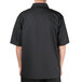 A man wearing a black Chef Revival chef coat with short sleeves.