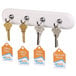 A white wall-mounted hook holding Avery scalloped tags with strings.