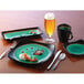 A Libbey stoneware plate with round detailing, a fork, and a knife on a table.