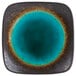 A Libbey stoneware plate with a square shape and a blue circle with brown spots.