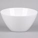 An American Metalcraft white melamine bowl with a white rim on a grey surface.