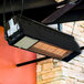 A Schwank natural gas black outdoor patio heater hanging from a ceiling.