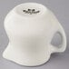 A white Tuxton china creamer with a handle.