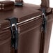 A dark brown Cambro insulated soup carrier with a black handle and two latches.