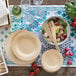 A table with Bambu wooden plates and salad on it.
