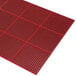 A red Cactus Mat commercial rubber mat with honeycomb holes.