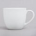 A Tuxton porcelain white mug with a handle.