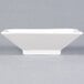 A white square bowl on a gray background.