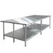 An Advance Tabco stainless steel work table with a galvanized undershelf.