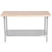 An Advance Tabco wood top work table with a stainless steel base and undershelf.