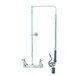 A T&S chrome wall mounted pre-rinse faucet with hose and swivel arm.