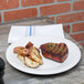A plate of steak and potatoes on a table.