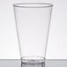 A Fineline Savvi Serve clear plastic tumbler on a white surface.