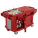 A red Cambro Versa Ultra work table with drinks and ice inside.