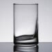 A close-up of a Libbey Lexington juice glass with a curved edge on a table.