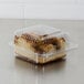 A Dart Clear plastic container with a piece of cake inside.