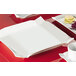 A CAC Times Square bright white square china plate.