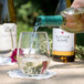 A person pouring wine into a Chef & Sommelier beverage glass.