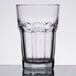 An Anchor Hocking New Orleans iced tea glass with a pattern on it and a curved edge.