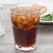a glass with ice and a piece of bread