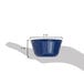 A hand holding a Carlisle cobalt blue fluted ramekin.