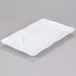 a white rectangular plate with a spoon