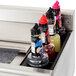 A close up of a drawer with bottles of liquid in an Eagle Group underbar ice bin.