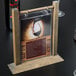 A Menu Solutions clear menu protector on a table with a wine glass.
