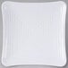 A white square Milano melamine plate with a spiral pattern.