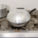 A Vollrath 11" silver domed cover on a pot.